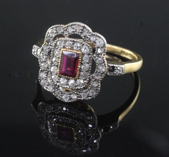 A mid 20th century 18ct gold, ruby and diamond cluster dress ring, size O.